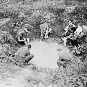Canadian troops make good use of a shell hole before an attack on Fritz's trenches