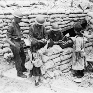 Canadians buying oranges and chewing gum from French girls, who are carrying their gas masks