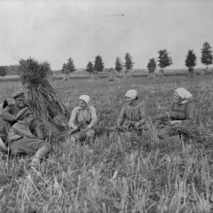 Two Canadians telling French girls how they won Hill 70