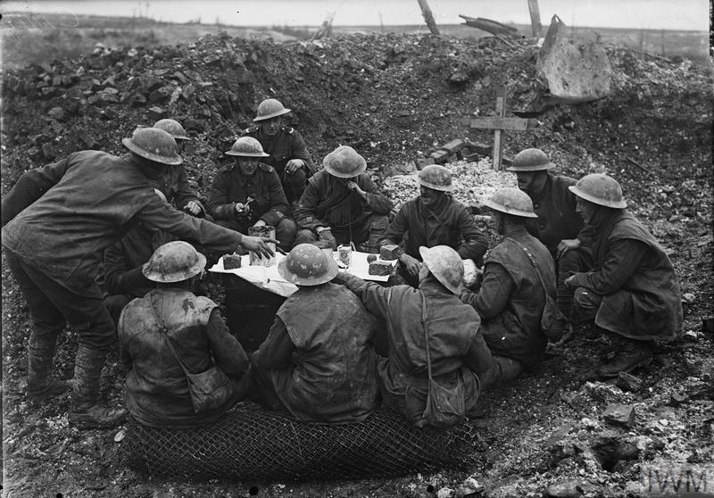 CHRISTMAS ON THE WESTERN FRONT, 1914-1918 (Q 1631) British troops eating their Christmas dinner in a shell hole, Beaumont Hamel, 25th December 1916 Copyright: © IWM. Original Source: http://www.iwm.org.uk/collections/item/object/205072886